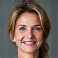 Sarah M., a woman in her late 40s smiling confidently.